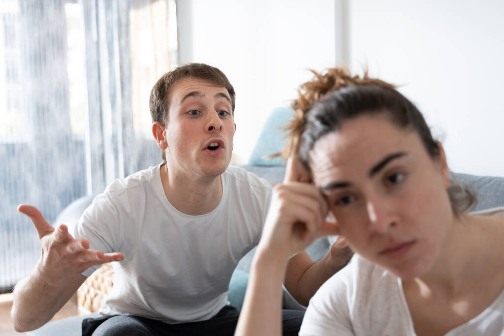 stock photo angry man shouting dispaired girlfriend couple cohabitation problems toxic relationship