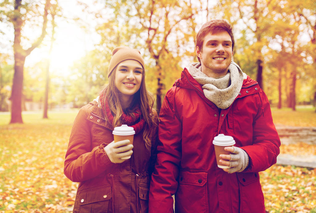 stock photo happy couple with coffee walking in autumn park