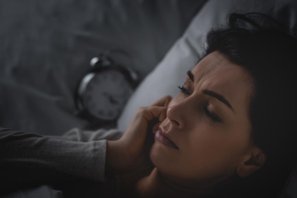 stock photo selective focus displeased woman insomnia lying bed alarm clock